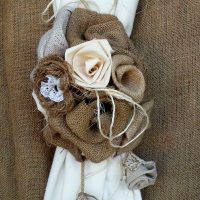 Burlap flowers on a white curtain