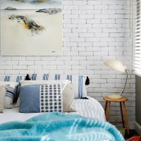 Blue bedspread on a white bed