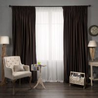 Stylish furniture in the living room with dark curtains