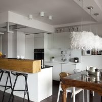 dark brown wood floor in a white kitchen