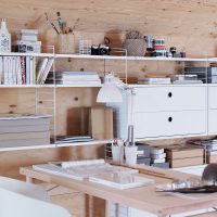 White shelving along a wooden wall