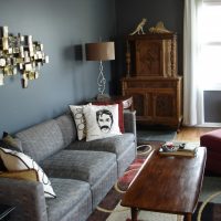 Decorative pillow with a portrait on a gray sofa