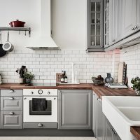 Corner kitchen with an apron under a brick