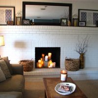 Burning candles in a decorative fireplace