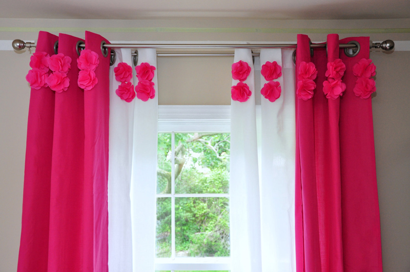 Red flowers on a white tulle in the hall of a private house