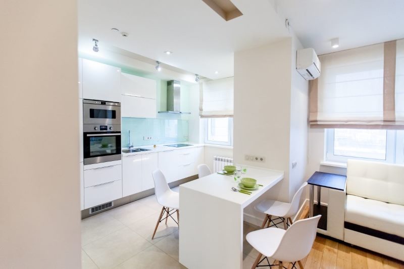 Minimalist white kitchen-living room