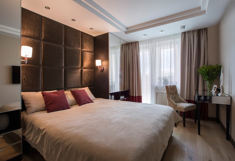 Two mirrored wardrobes in the bedroom interior