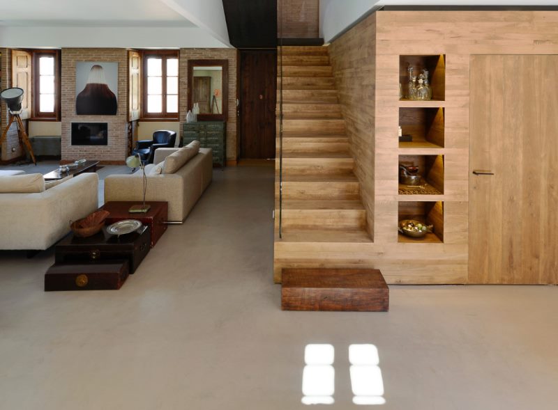 Wooden staircase on a white ceramic floor