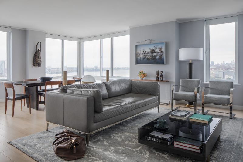 Living room interior with gray sofa in the middle