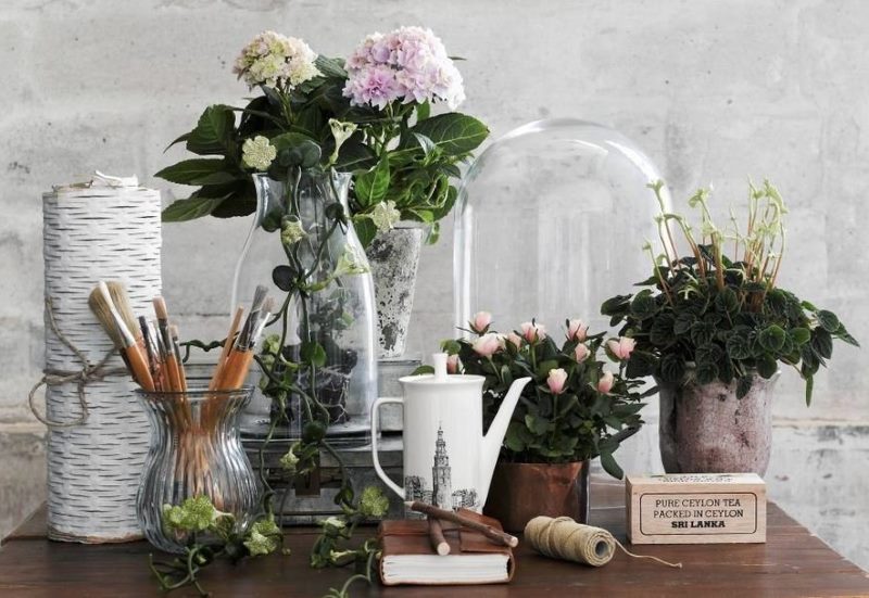 Composition with fresh flowers on a small table