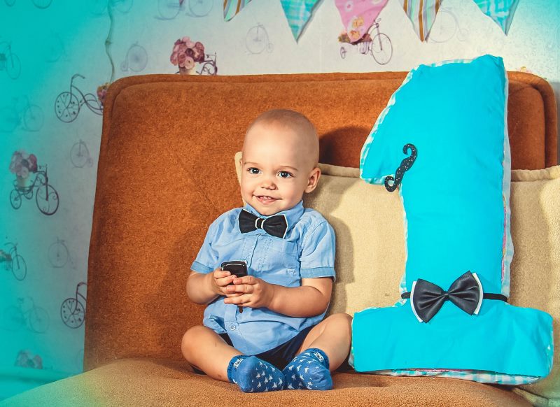 Photo of a one-year-old baby next to a three-dimensional figure