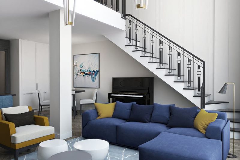 Concrete staircase with metal railing in a two-level apartment