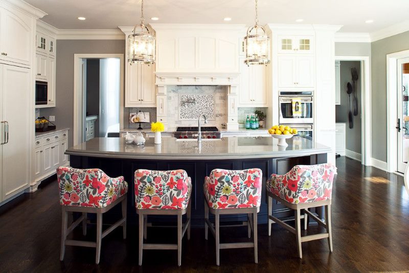 Bright armchairs in the interior of a gray kitchen