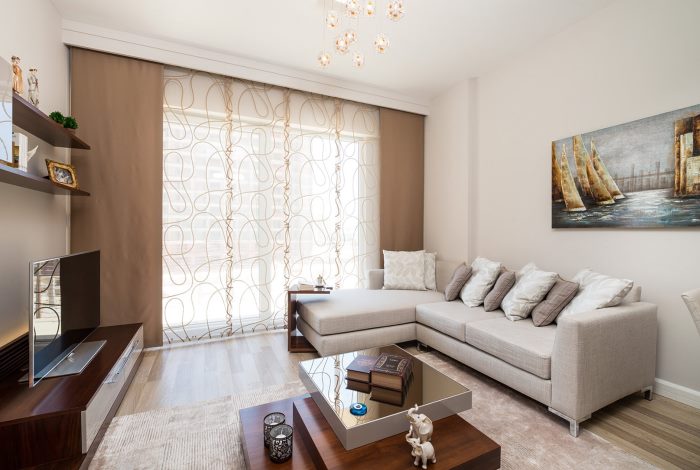 the decoration of the living room window with brown curtains