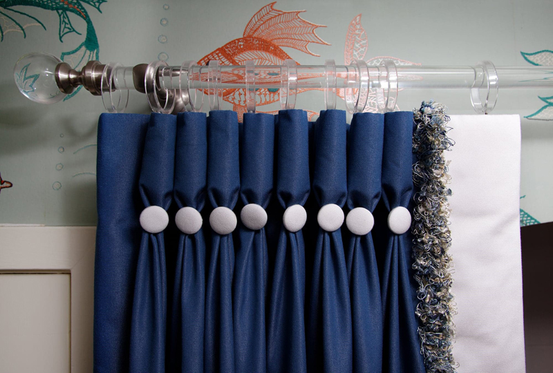 Folds with decorative buttons on the curtains in the bedroom