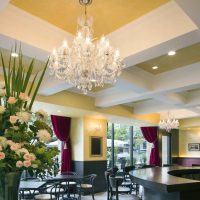 Glass chandelier on the yellow ceiling