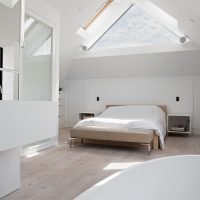 The interior of the bedroom in the attic of a country house