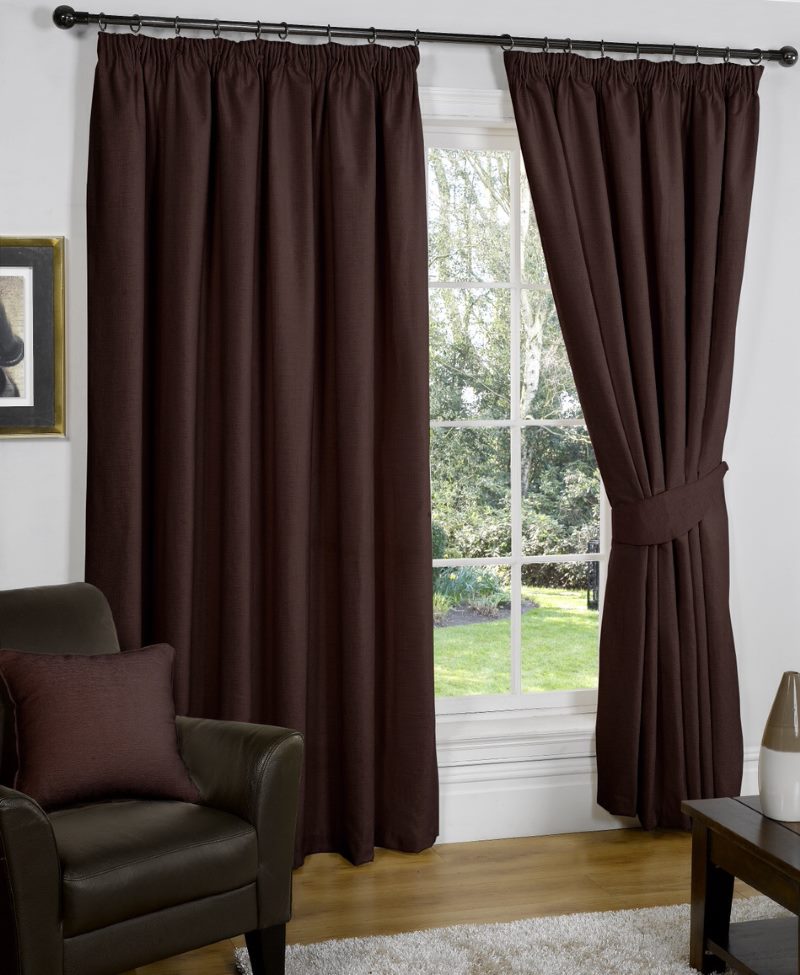 Saturated dark brown curtains on the living room window in a private house