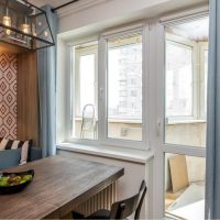 Wooden table in front of the kitchen window