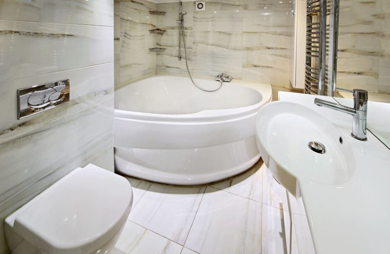 Acrylic corner bath in a small bathroom