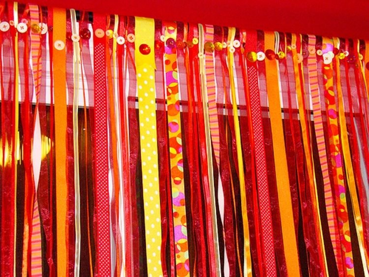 Window curtain made of satin ribbons and buttons