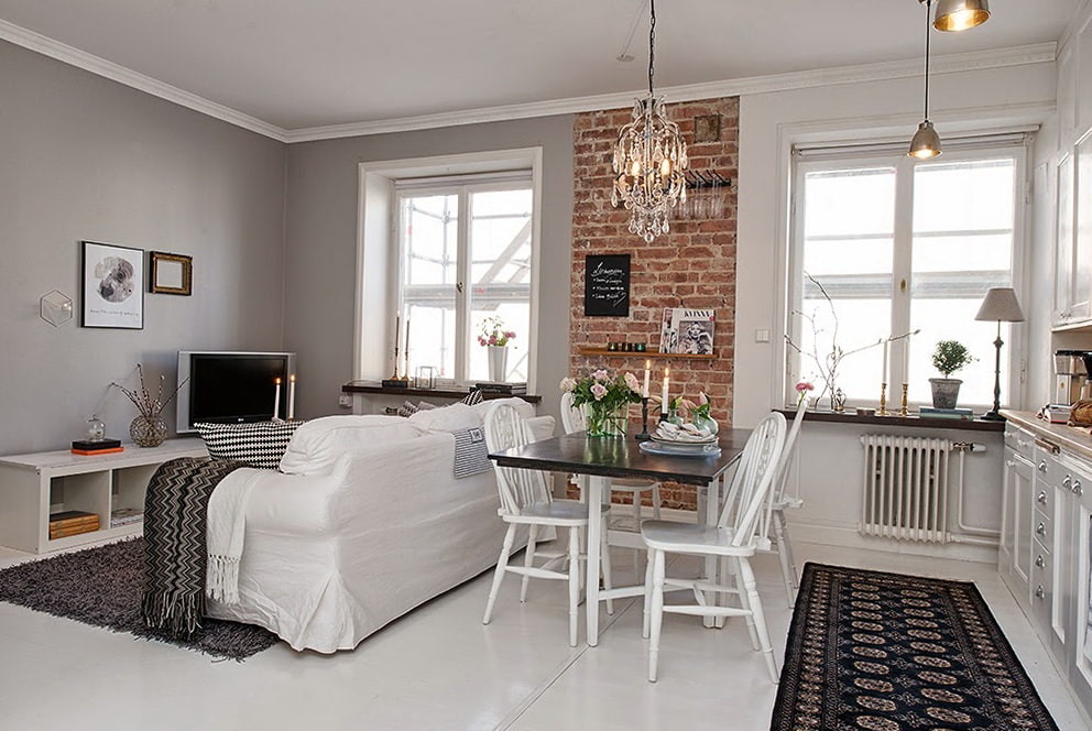 Brick in the interior of the kitchen-living room of the Scandinavian style