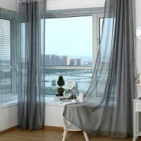 Coffee table by the window with light curtains