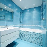 White bathroom sideboard with blue tiles