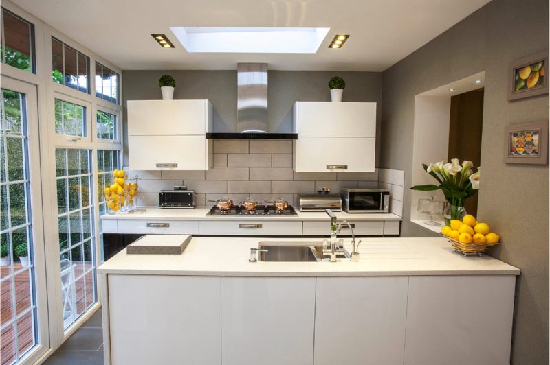 Yellow lemons in cups on kitchen worktops