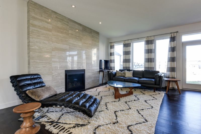 Interior of a large living room with gray striped curtains