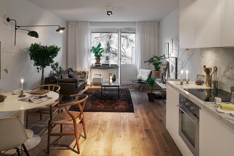 Scandinavian-style kitchen-living room with balcony