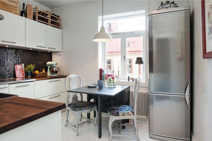 Kitchen fridge with dining area.